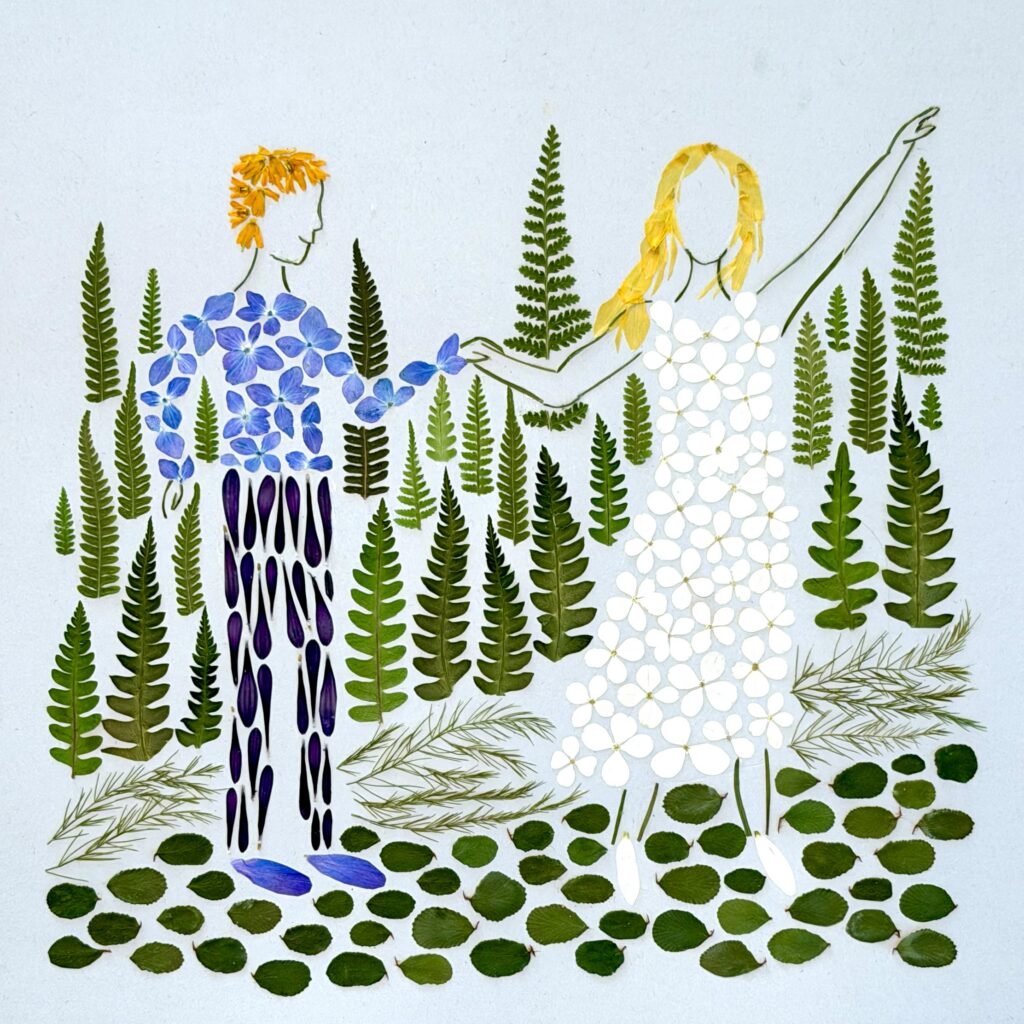 Pressed flower artwork of a couple, one figure in blue petals and one in a white petal dress, framed by ferns