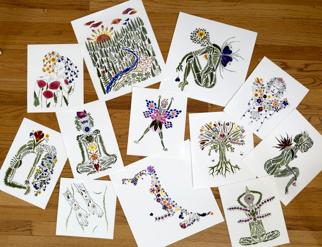 A collection of pressed flower fine art prints laid out on a wooden floor